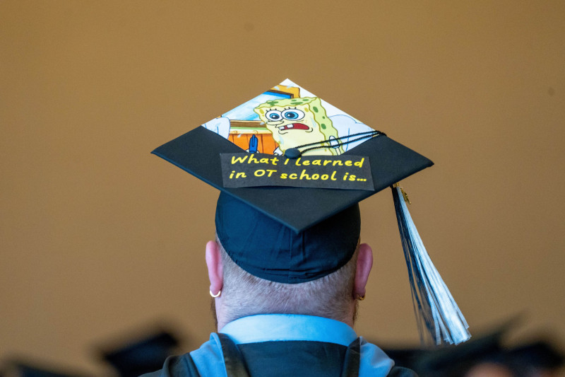 A Governors State University graduate wearing their SpongeBob decorated graduation cap