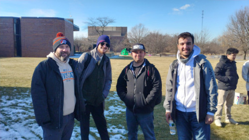 Photo of four Governors State University students outside on campus