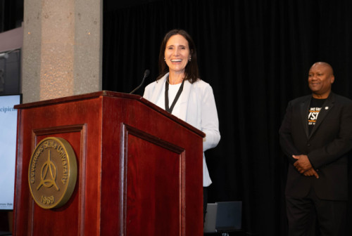 A woman speaking at a podium for Distinguished Alumni Reception 2024