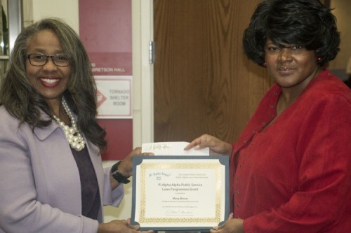 Dr. Mary Bruce and Ms. Tasha Baker hold up the grant certificate for a $500 Public Service Loan Forgiveness grant earned by the chapter in 2017