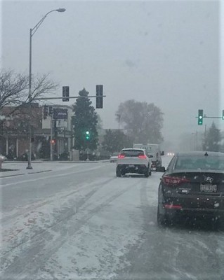 snow falling on traffic