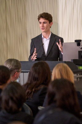 Governors State University alum speaking at a podium for honor pining ceremony