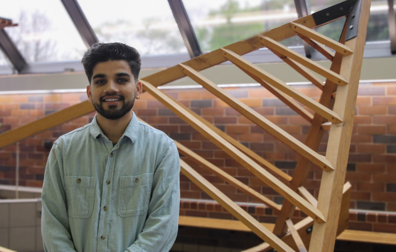 Portrait photo of a Governors State University student in front of a campus sculpture