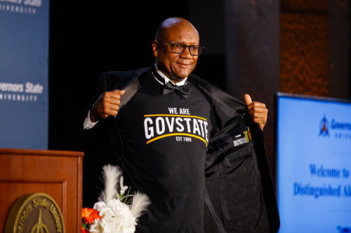 A man showing off his GovState t shirt