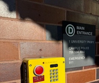 A 911 phone located at the D main entrance of Governors State University