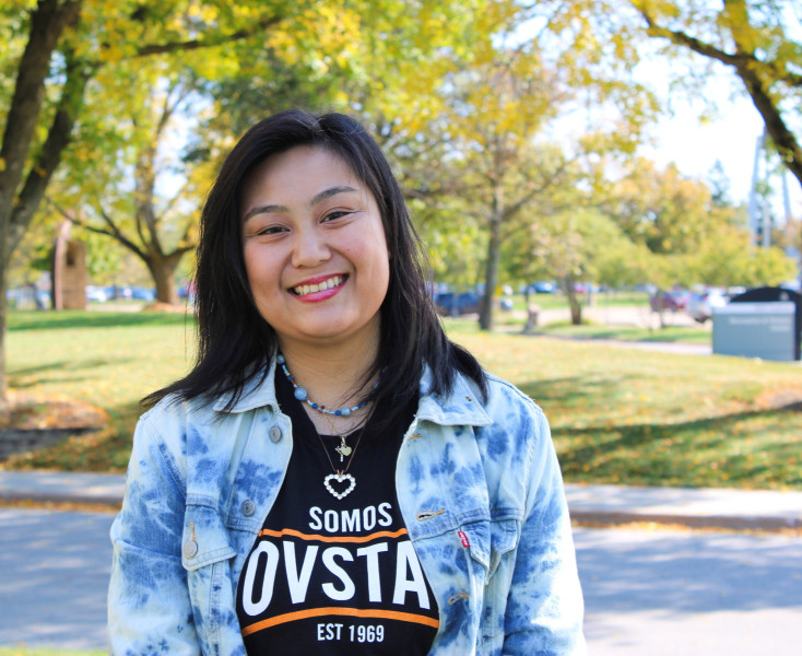Portrait photo of a smiling woman Journey Manual wearing a Spanish Governors State University shirt and jean jacket