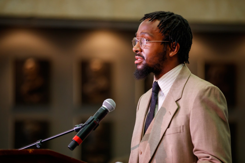 Governors State University student senate president Xavier Thompson speaking at a podium