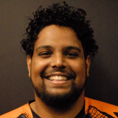 A headshot of a smiling man