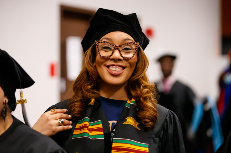 Tiffany Fincher in doctoral regalia at Governors State University Doctoral Hooding Ceremony