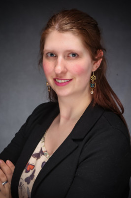 Headshot of a smiling woman Melissa Plakke wearing business casual clothes