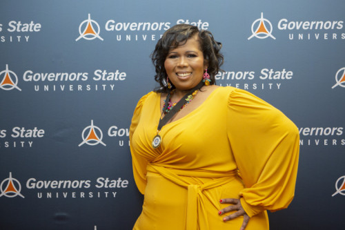 A woman smiling in front of GovState backdrop
