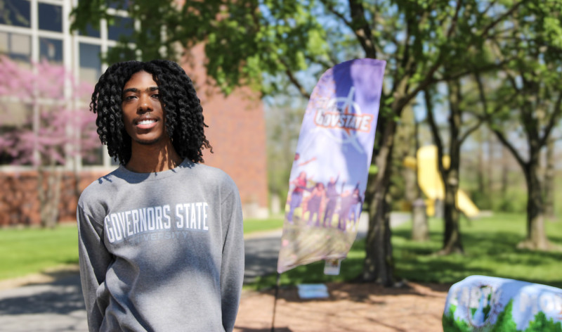 Portrait photo of a Governors State University student in front of a campus banner