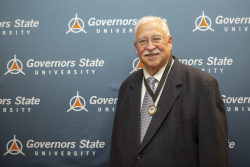 An older gentleman smiling in front of GovState backdrop