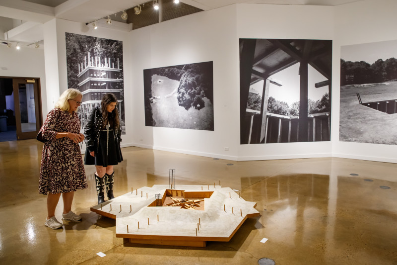 Two women viewing an art gallery exhibit at Governors State University