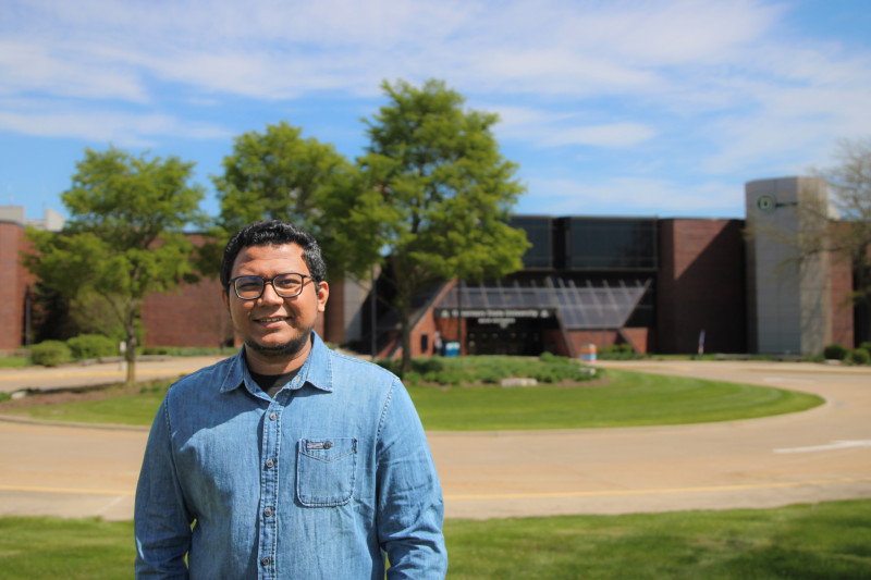 Portrait photo of a Governors State University student in front of the campus building