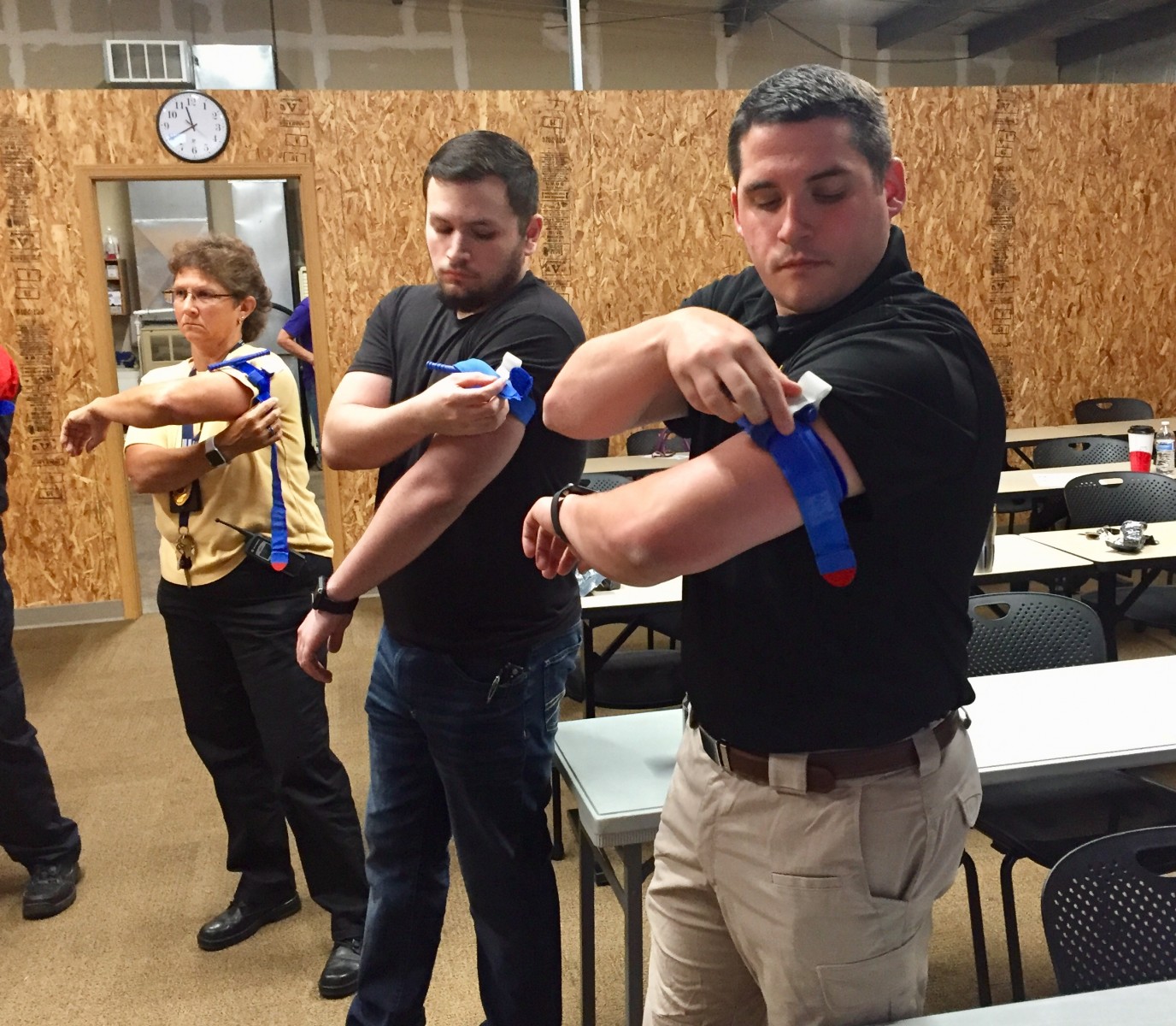 Practicing wrapping tourniquet on arm wide