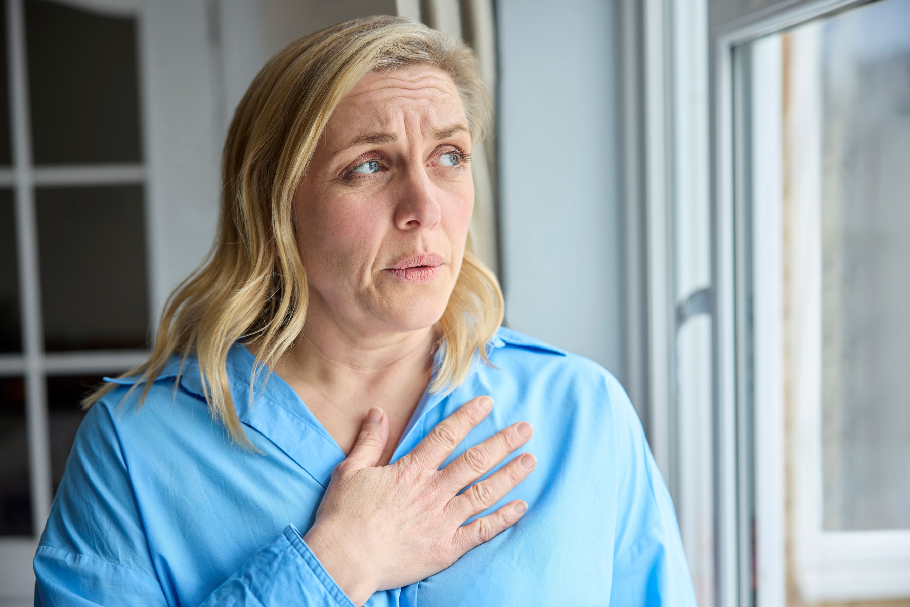 women holding her chest - stock photo of woman  holding her chest women holding her chest