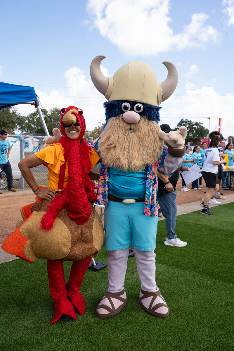 Carla Gamez-Vela and Valdar - Carla Gamez-Vela, Assistant Professor of Kinesiology and Intramural Sports Directo, poses in a turkey costume with Valdar the Viking during Del Mar College's Turkey Bowl 2025 held on the Heritage Campus on Oct. 24. Carla Gamez-Vela and Valdar