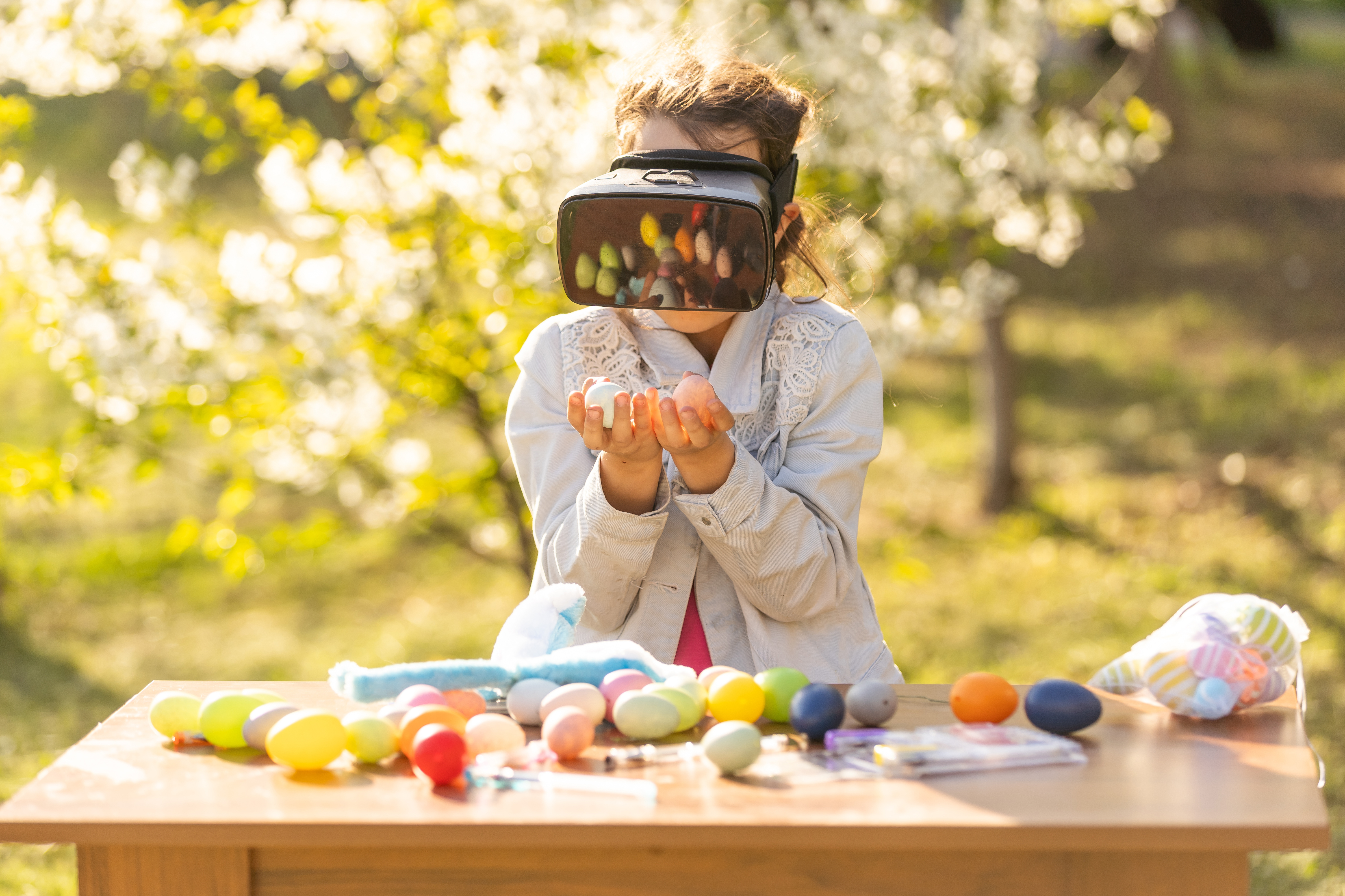 Teenage girl with easter egg in virtual glasses