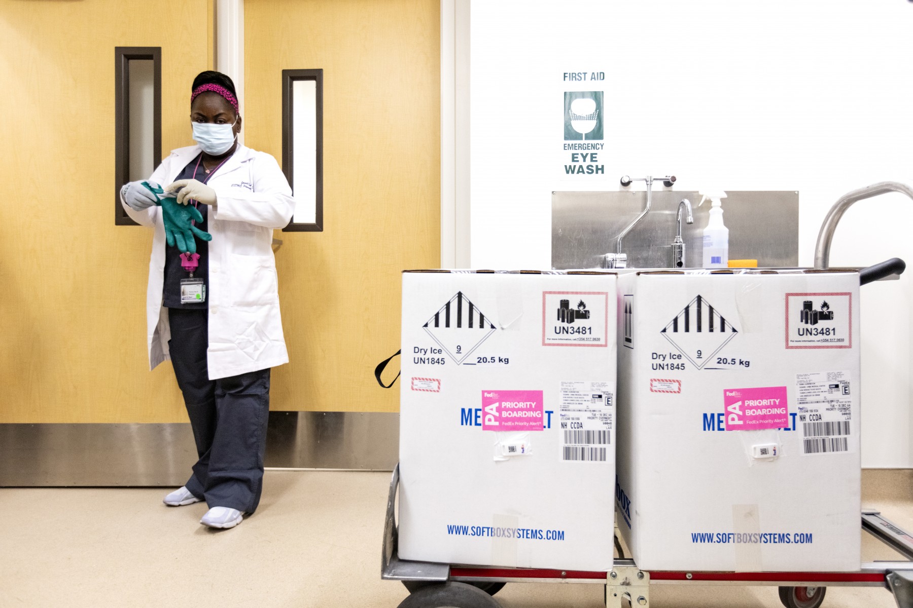 Pharmacy technicians Janelle Dunn, left, and Ashenafi Abebe receive