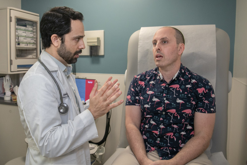 Bobak Akhavan, MD, discusses the treatment plan with patient Jake Raden.  Photo by Cedars-Sinai.