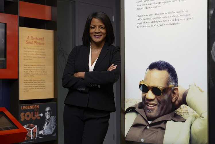 The Ray Charles Foundation President Valerie Ervin with a photo of the music legend at the foundation headquarters in Los Angeles. Photo by Cedars-Sinai.