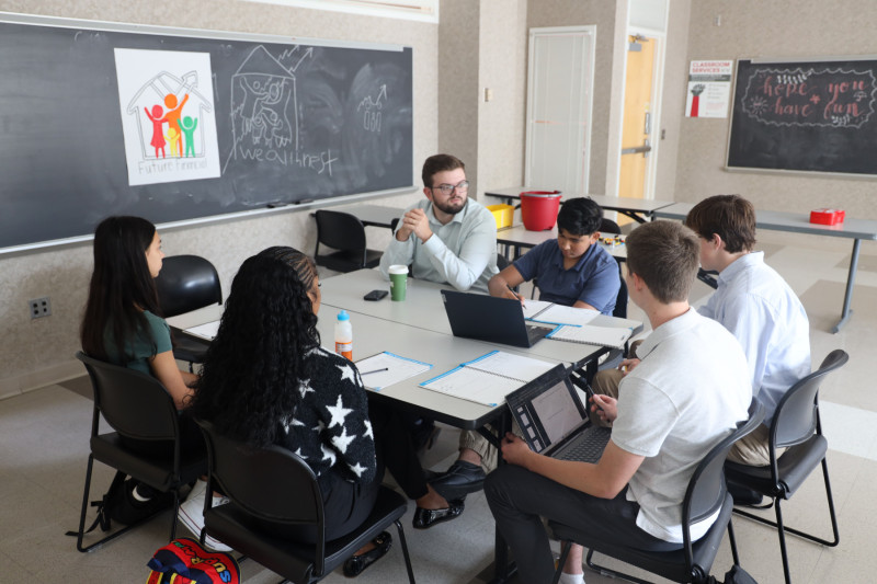 Cameron Oletli's financial scheme gave students' observations on their presentations.