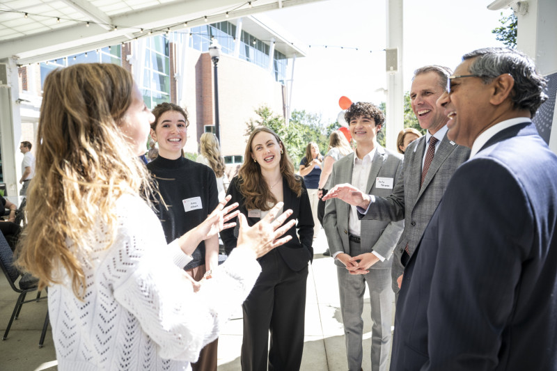 President Bellamkonda (far right) and Eric Zimpfer (second from right) speak to Ohio State students.