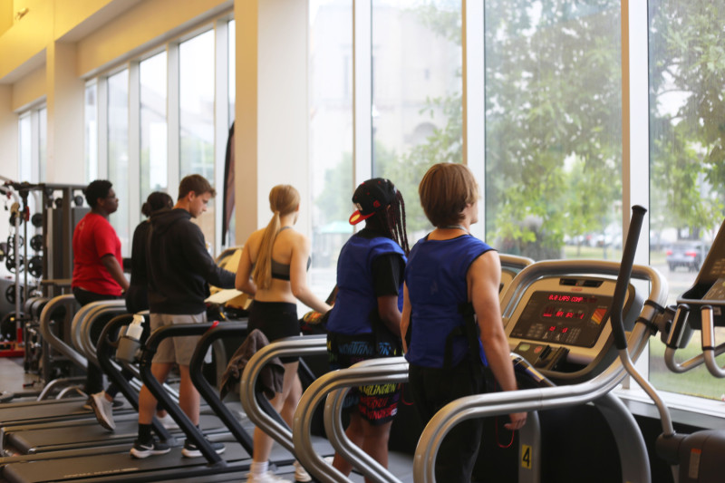 Science of Athletic Performance students participate in an experiment to measure how cooling vests affect endurance on treadmills.