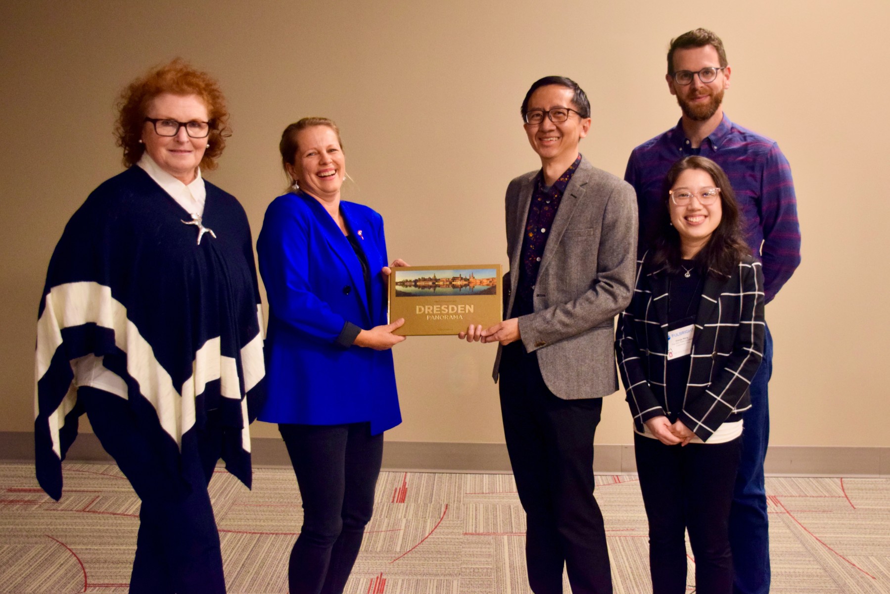 German Fulbrighter Katja Krautz (second from left), from Dresden, presents the Ohio State team with a book about Dresden, a Columbus sister city. Receiving the book are (L-R) Joanna Kukielka-Blaser, director, Fulbright Scholar and Fulbright-Hays Programs, Ohio State Office of International Affairs; Ivan Stefano and Francis Troyan, seminar co-directors; Zhenjie Weng, new PhD in multilingual language education.