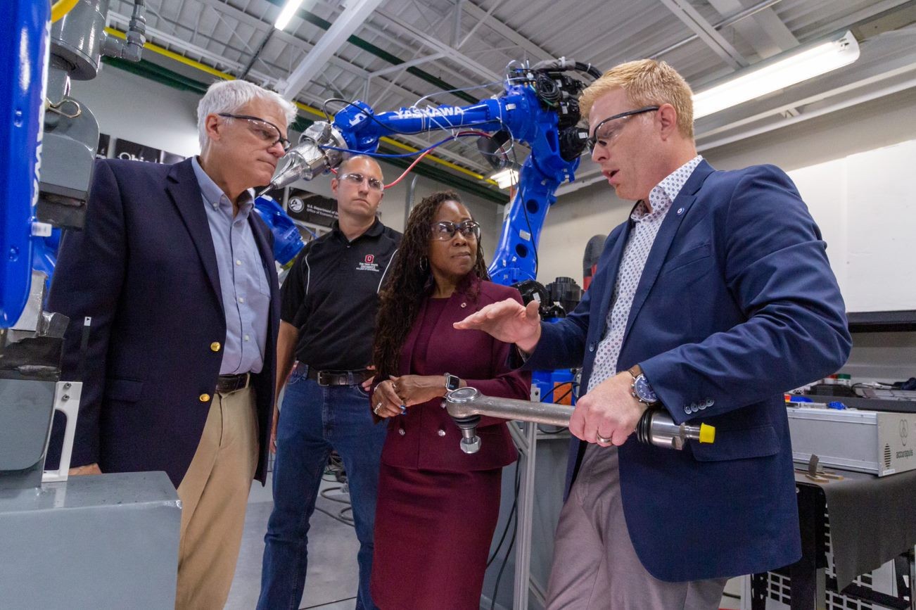 HAMMER Director Glenn Daehn (left) discusses advance manufacturing at the AIMS Lab with Nate Ames, Dean Ayanna Howard and Michael Groeber