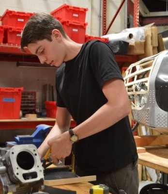 Dominek bending wood to create the frame for the Supermileage vehicle