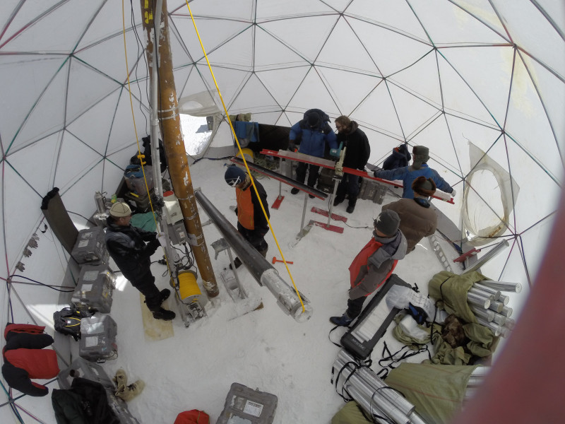 Researchers take samples from the Guliya Plateau inside of a core drilling dome in 2015.