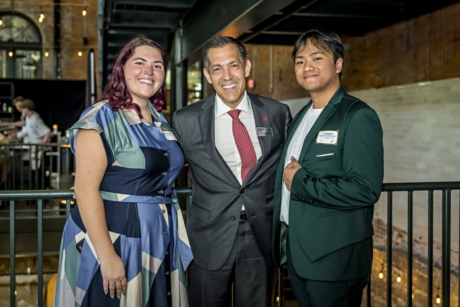 EHE Interim Dean Erik Porfeli (center) with hospitality management students Danielle Johnson and Jv Velasquez.