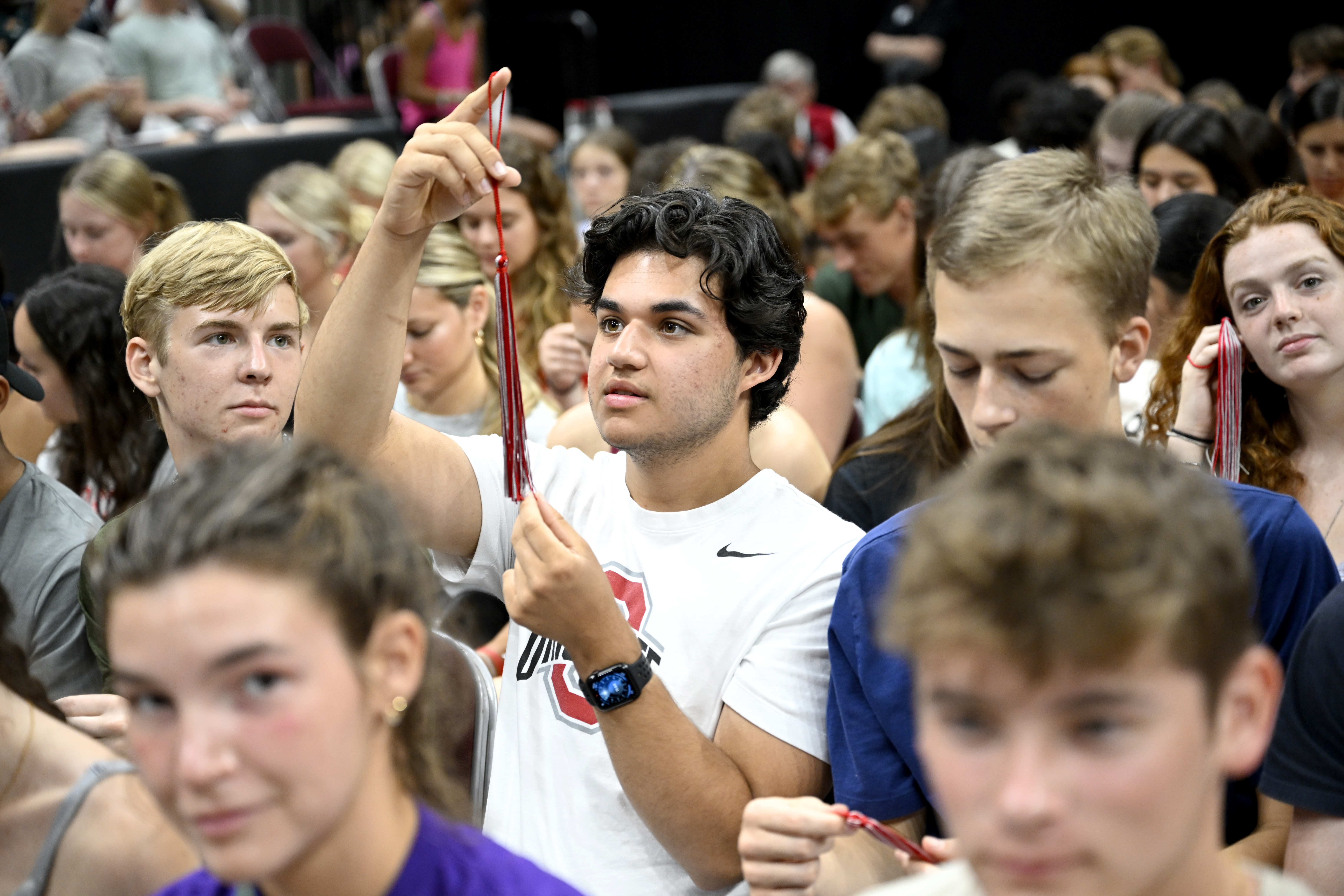 A student looks at his scarlet and gray tassel. All incoming students received them as gifts from the Alumni Association.