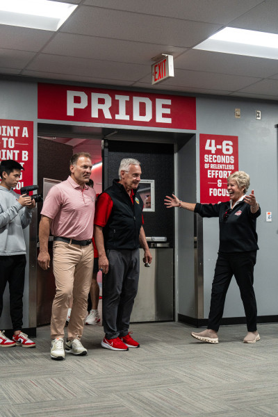 Jim Tressel (center) is congratulated by his wife Ellen and Ohio State Athletic Director Ross Bjork.
