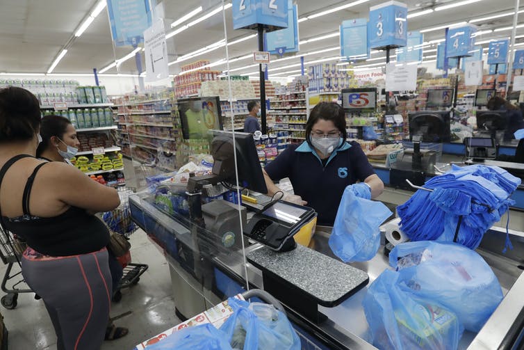 Shoppers paying for goods at a retail store