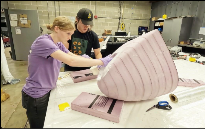 Ohio State students Emmaline Blose and Carson Nietert fabricating part of fuselage.