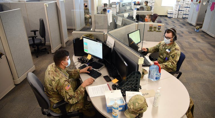 Arizona National Guard members conduct exposure notification calls.