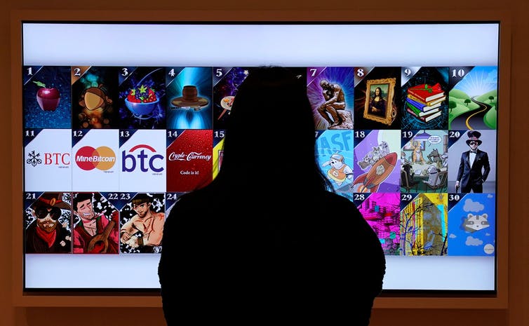 A woman looks at a non-fungible token digital art display in New York City in September 2021.