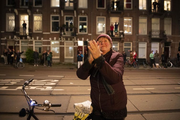 People take part in a ‘applause for care’ flash mob