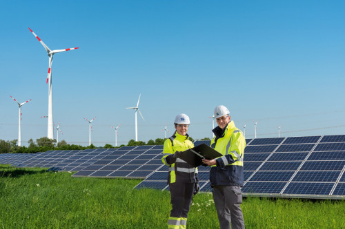 Wind engines and solar panels on a sunny day seen in Germany