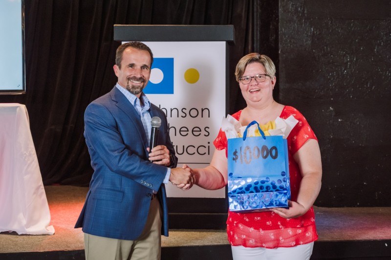 Scott Vorhees shakes hands with Jen Black, advisory board member of Building Bridges. Photo credit: Mark N Photography