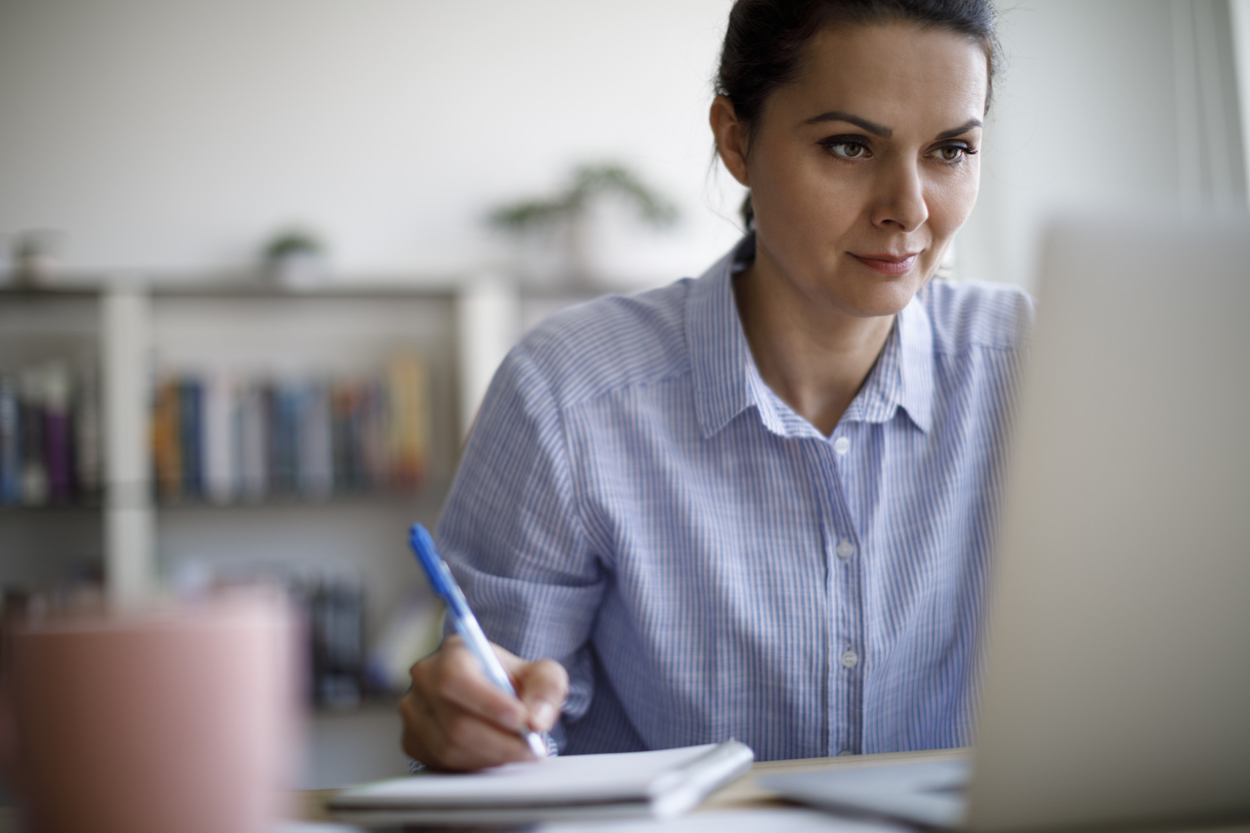 2025-06-11_Female_Working_On_Laptop_Writing_1215772487