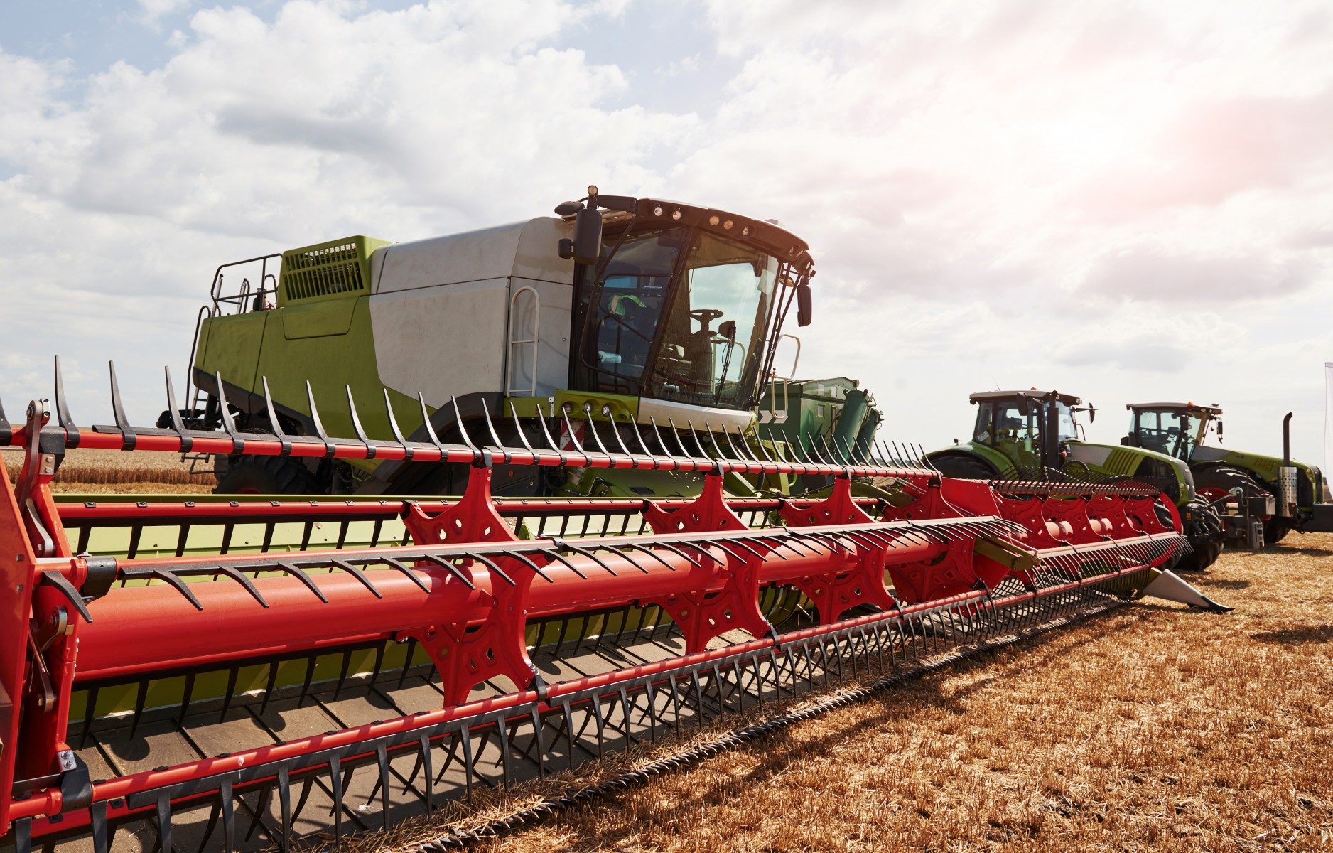 Large combine harvesters parked in agriculturic field at summertime