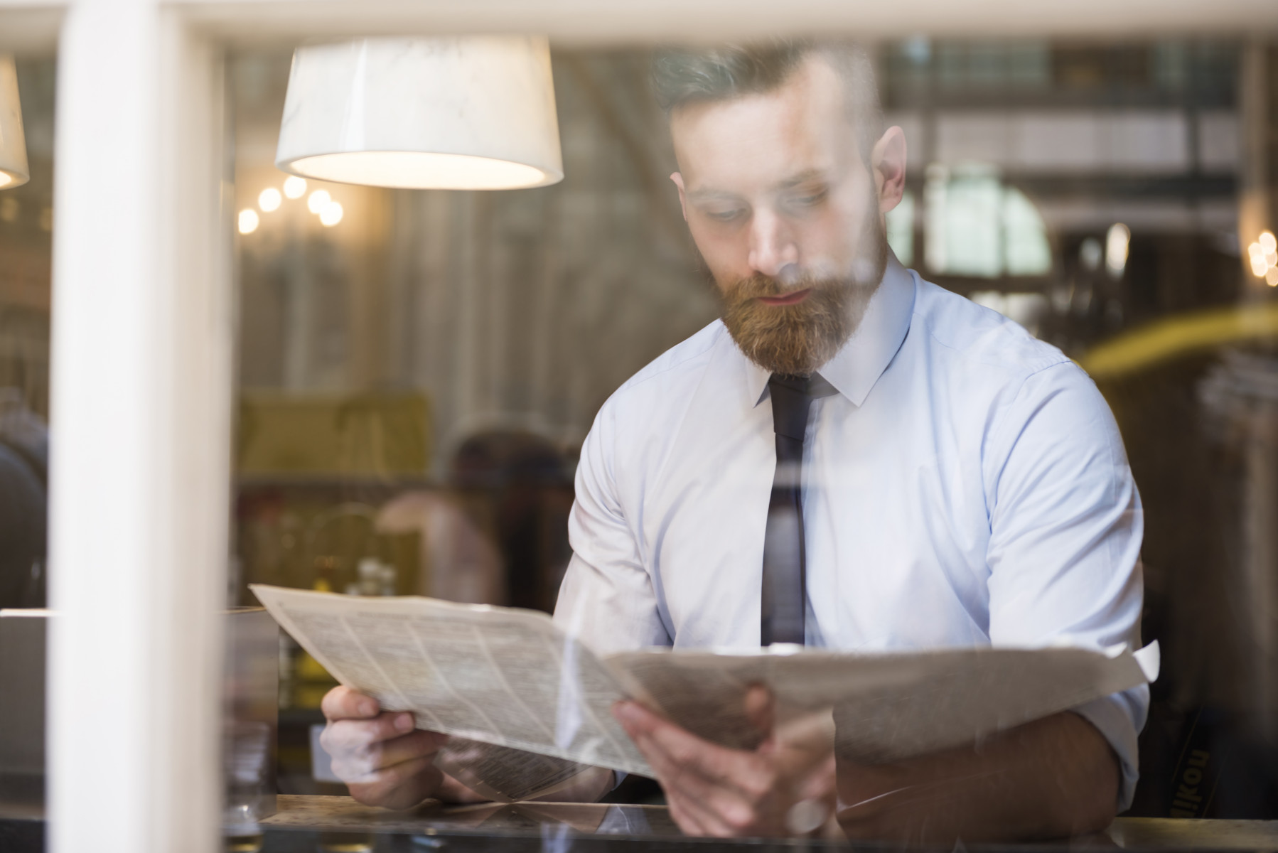 young-businessman-reading-newspaper