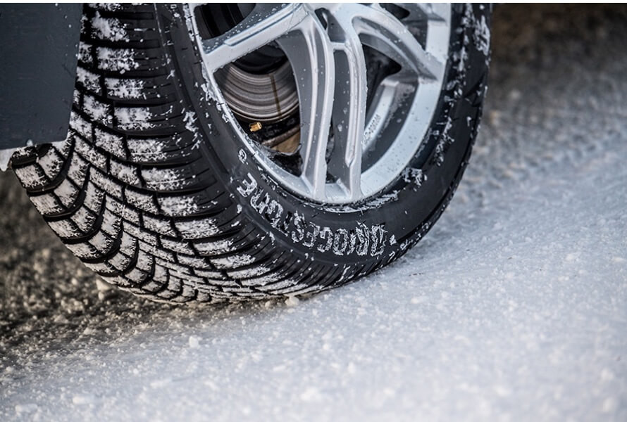 a_close_up_of_a_blizzak_lm005_tyre_with_snow_packed_into_the_treads-2