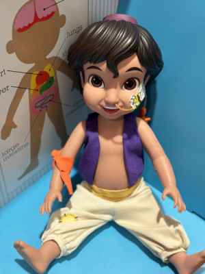 Props like this Aladdin doll help kids feel more comfortable with feeding tubes and IVs.