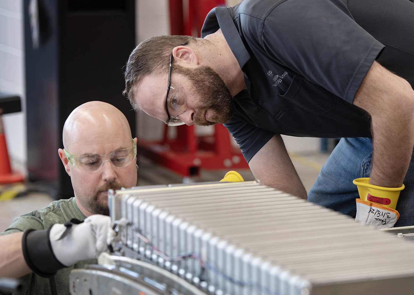 Licenced Automotive Service Technician Matt Pazzi and Paul Vandervelde train on servicing an electric battery