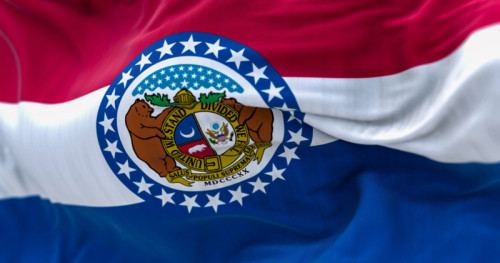 Close-up of the Missouri state flag waving. Red, white, blue horizontal stripes with Great Seal of Missouri in center. 3d illustration render. Textured background. Selective focus. Fluttering textile